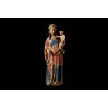 A MID 14TH CENTURY FRENCH POLYCHROME, GILDED AND CARVED LIMESTONE GROUP OF THE VIRGIN AND CHILD,