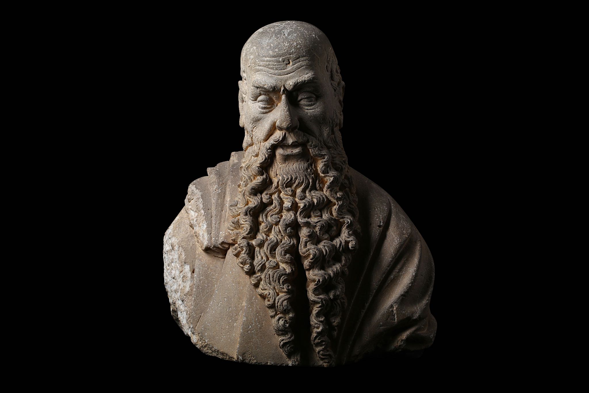 AN IMPORTANT LATE 15TH CENTURY ITALIAN CARVED SANDSTONE BUST OF A BEARDED MAN, CIRCLE OF ANGELO DI