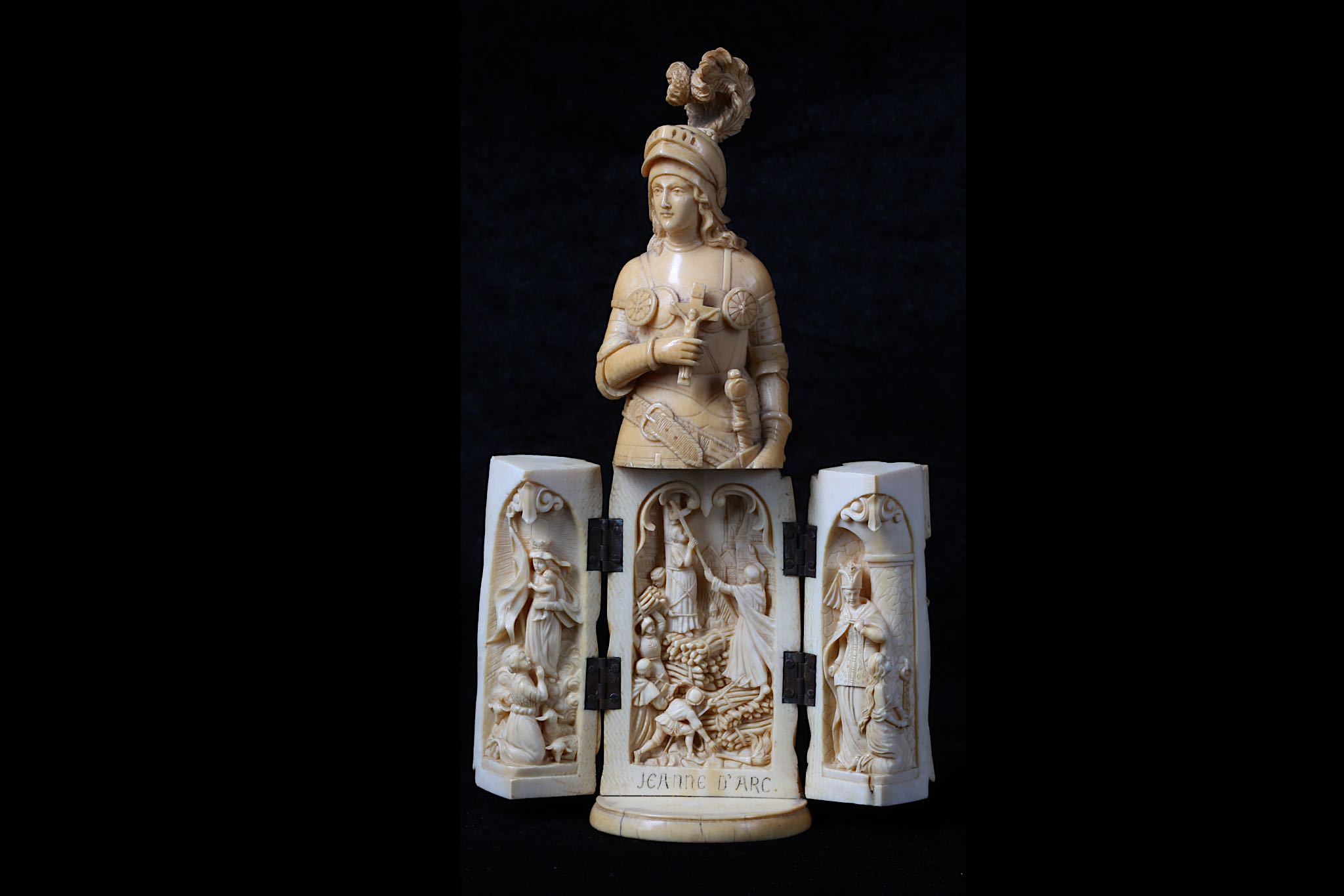 A 19TH CENTURY DIEPPE IVORY TRIPTYCH FIGURE OF JOAN OF ARC the standing figure holding a shield in