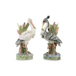 TWO EARLY 20TH CENTURY MAJOLICA POTTERY STICK STANDS MODELLED AS STORKS ATTRIBUTED TO DELPHIN