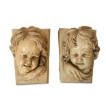 A PAIR OF LATE 19TH CENTURY GLAZED TERRACOTTA CHERUB MASK KEYSTONES BY LIPSCOMBE & CO. AFTER THE