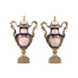 A PAIR OF LOUIS XV STYLE PORCELAIN AND GILT BRONZE MOUNTED VASES AND COVERS in the Sevres style, the