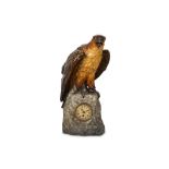 A FIRST HALF 20TH CENTURY AUSTRIAN PAINTED CLOCK MODELLED WITH AN EAGLE raised on a rocky plinth