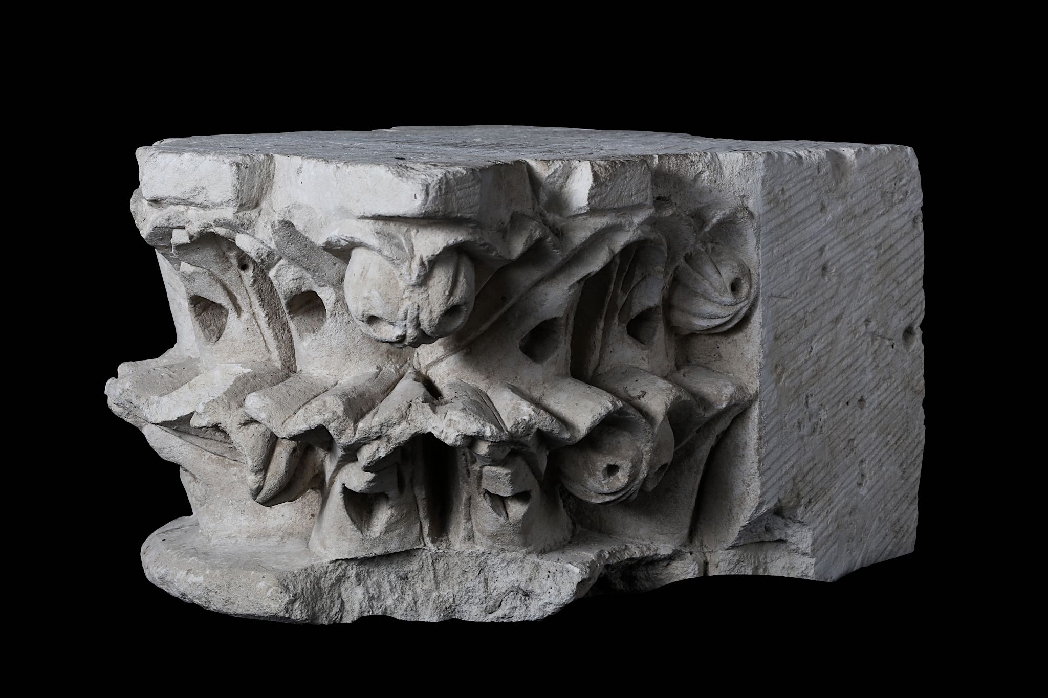 A FRENCH GOTHIC CARVED LIMESTONE CORBEL, POSSIBLY 12TH CENTURY carved with stylised fruit and