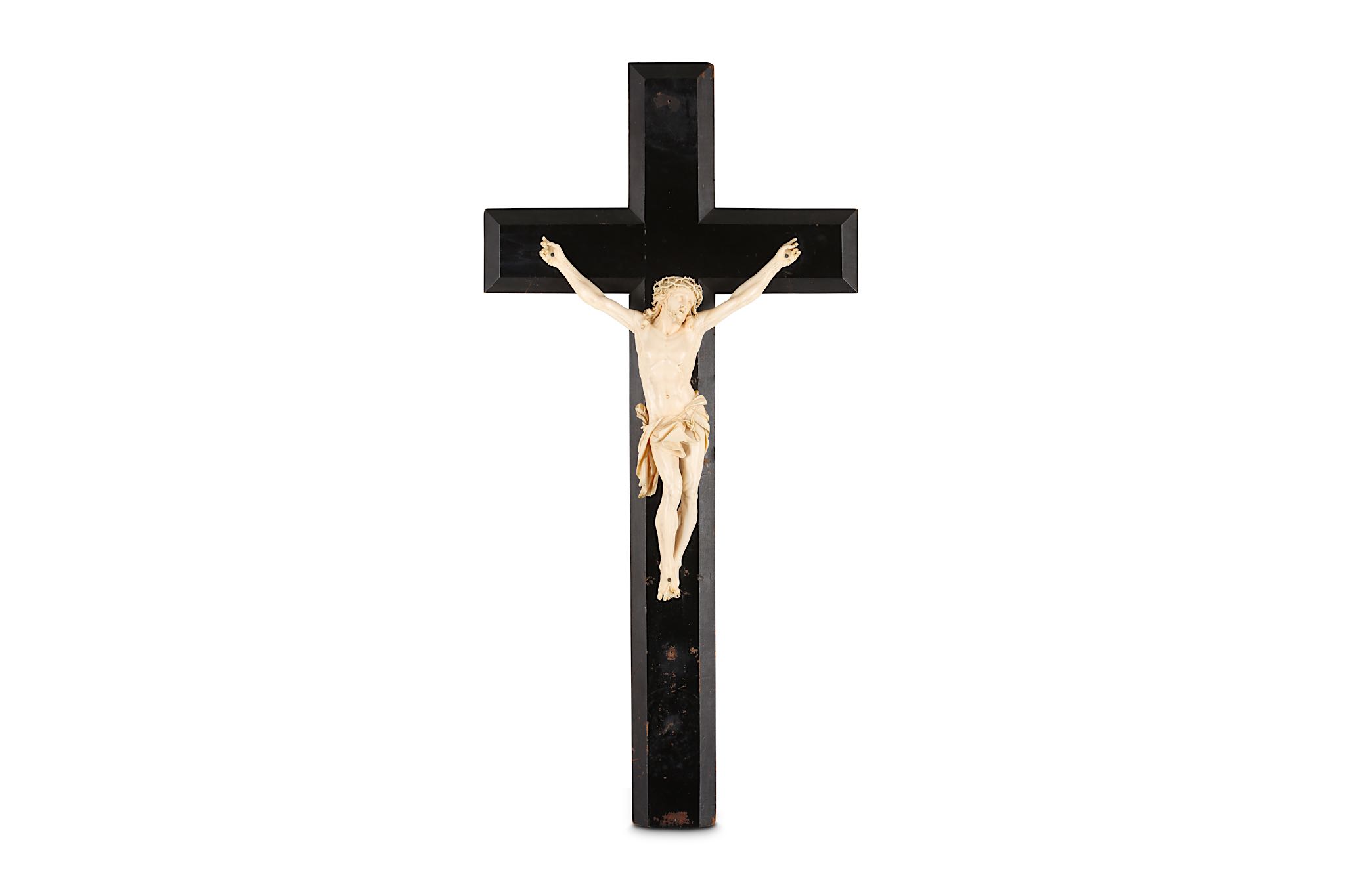 A 19TH CENTURY CARVED IVORY CRUCIFIX the Corpus Christi figure of Christ depicted wearing the