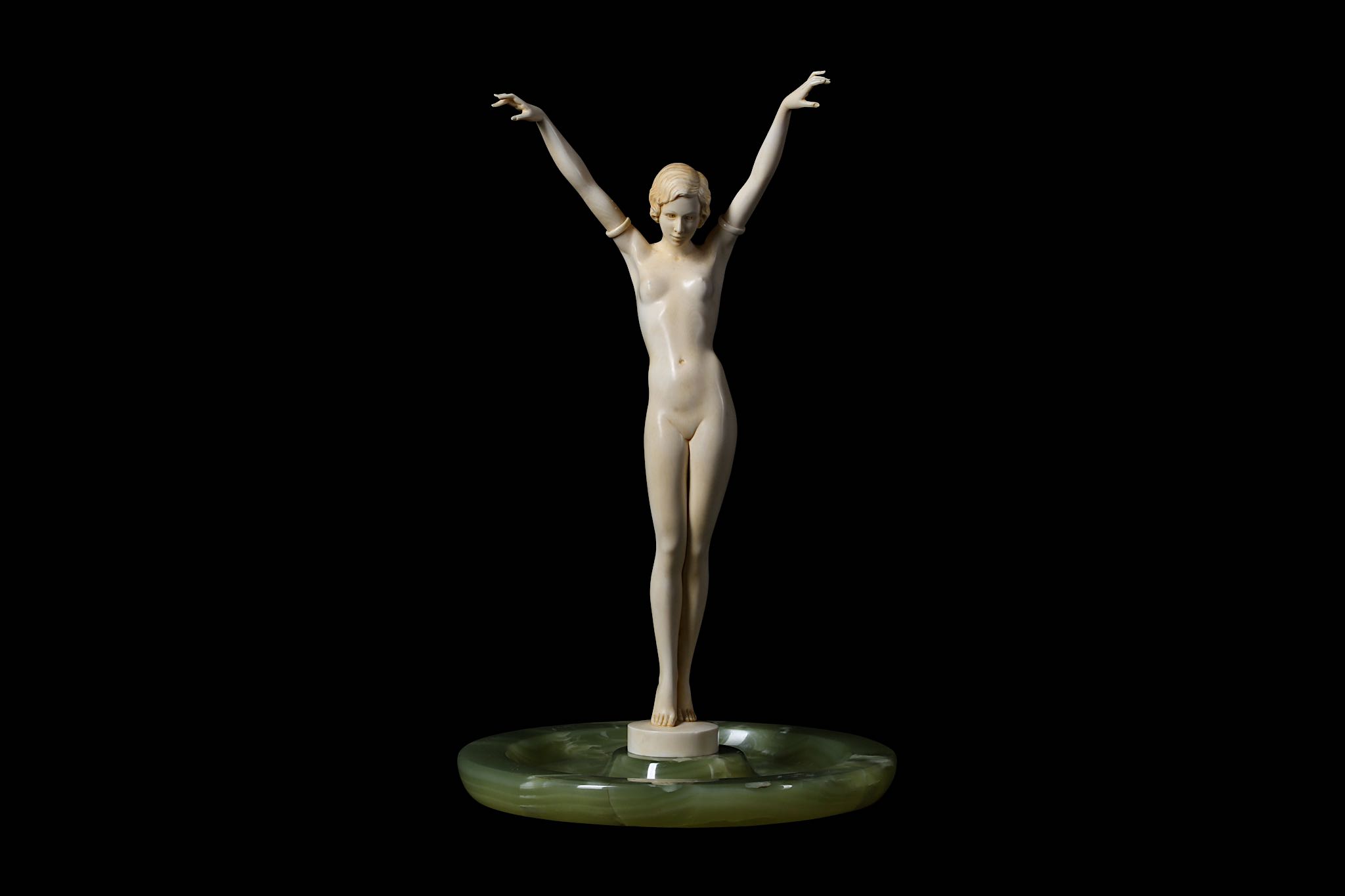 A FRENCH ART DECO PERIOD CARVED IVORY FIGURE OF A NUDE GIRL CIRCA 1920 the standing figure with both