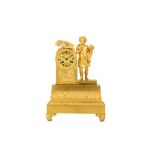 A SMALL EARLY 19TH CENTURY EMPIRE PERIOD GILT BRONZE MANTEL CLOCK DEPICTING A YOUTH the