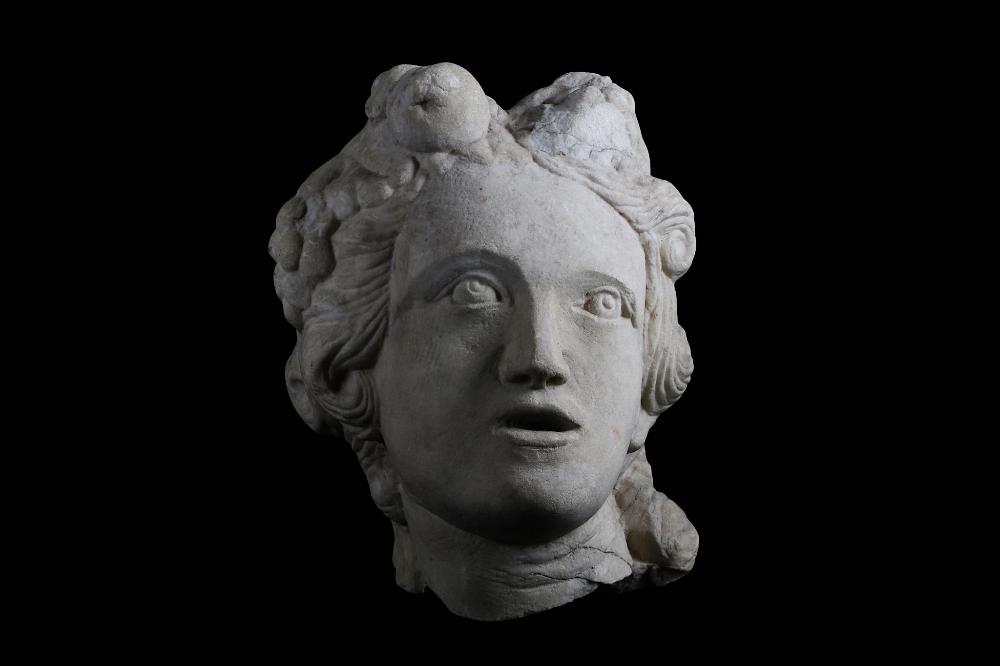 A 17TH CENTURY ITALIAN MARBLE HEAD OF A BACCHANTE / CERES her mouth open and her hair adorned with