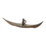 A INUIT SEAL SKIN KAYAK The long kayak with upturned ends terminating in ovoid knobs, the separately