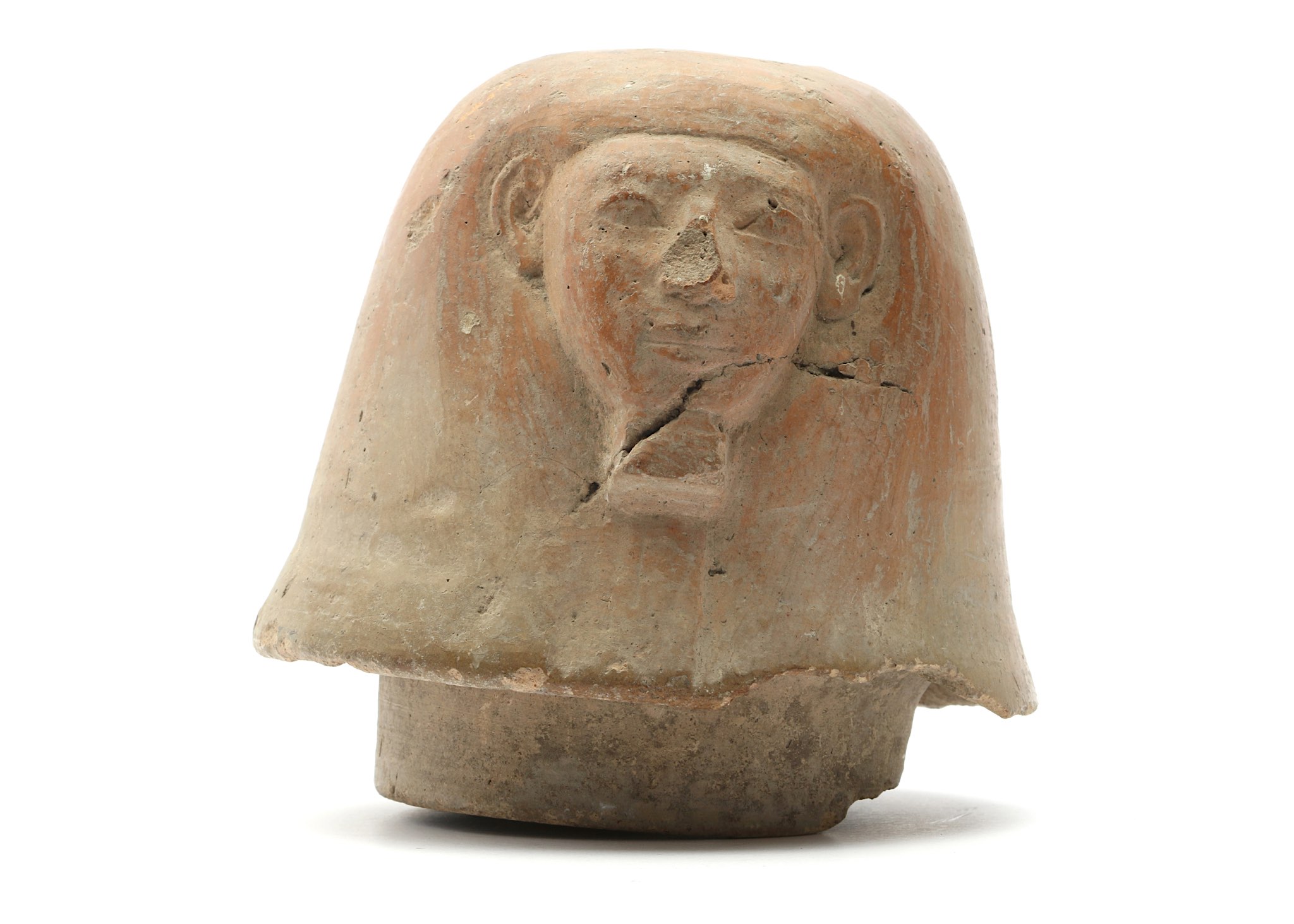 A TERRACOTTA CANOPIC JAR LID New Kingdom, Circa 1550 - 1070 B.C. Of human-headed Imsety, the