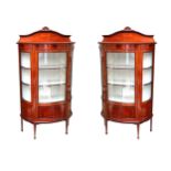 A pair of Edwardian chequer and boxwood strung mahogany bowfront display cabinets, each enclosed