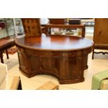 A good quality reproduction George III style oval mahogany pedestal partners desk, the gilt tooled