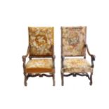 A pair of Renaissance style walnut open armchairs, early 20th Century, tapestry upholstered, the