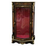 A large Boulle style serpentine front ebonised display cabinet, applied with gilt metal mounts, on a