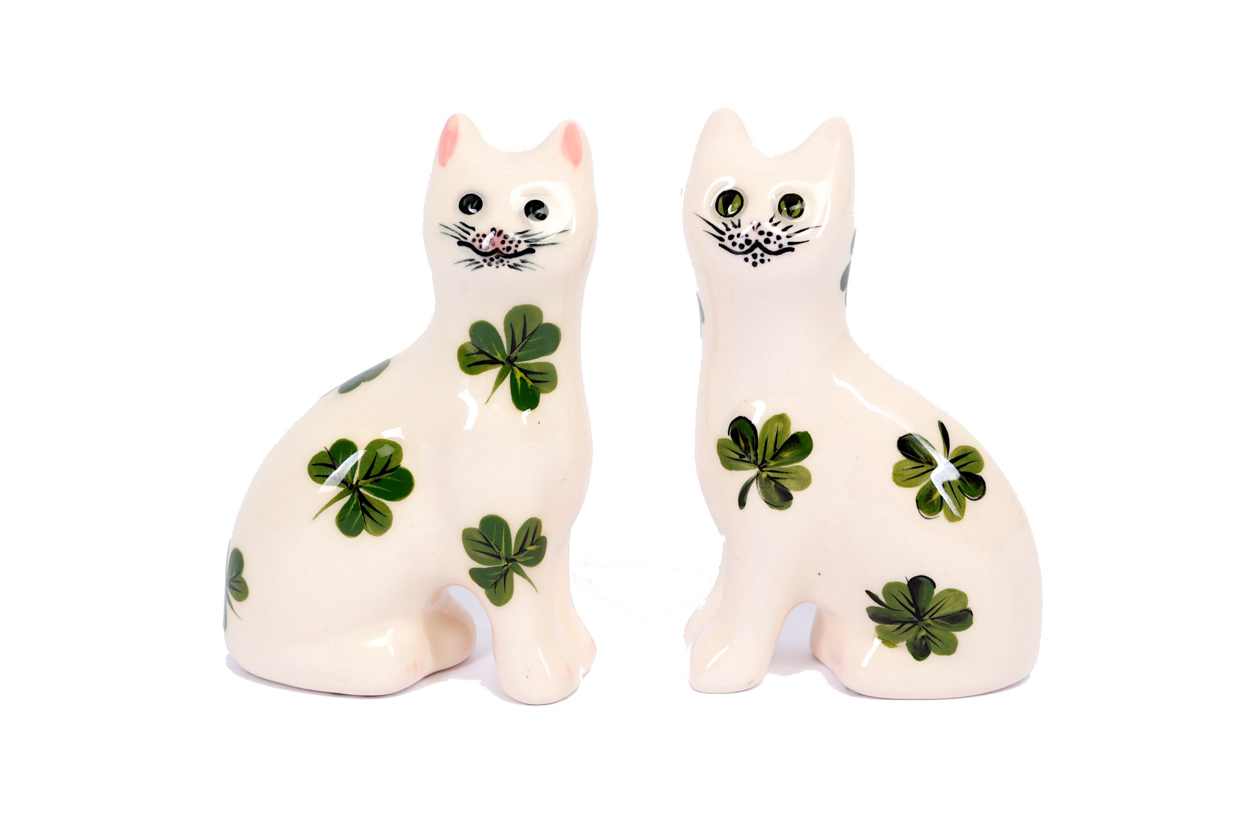 A small pair of Wemyss pottery cats, 20th Century, with green Shamrock decoration on a white ground,