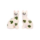 A small pair of Wemyss pottery cats, 20th Century, with green Shamrock decoration on a white ground,