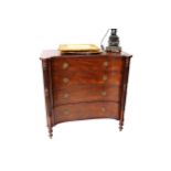 A Regency design mahogany concave front chest, fitted with four graduated long drawers, flanked by