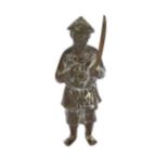 A bronze and patinated brass figure, 19th century, modelled as a peasant soldier with sword, 17cm