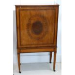 A George III banded satinwood side or music cabinet, the single door marquetry inlaid with a