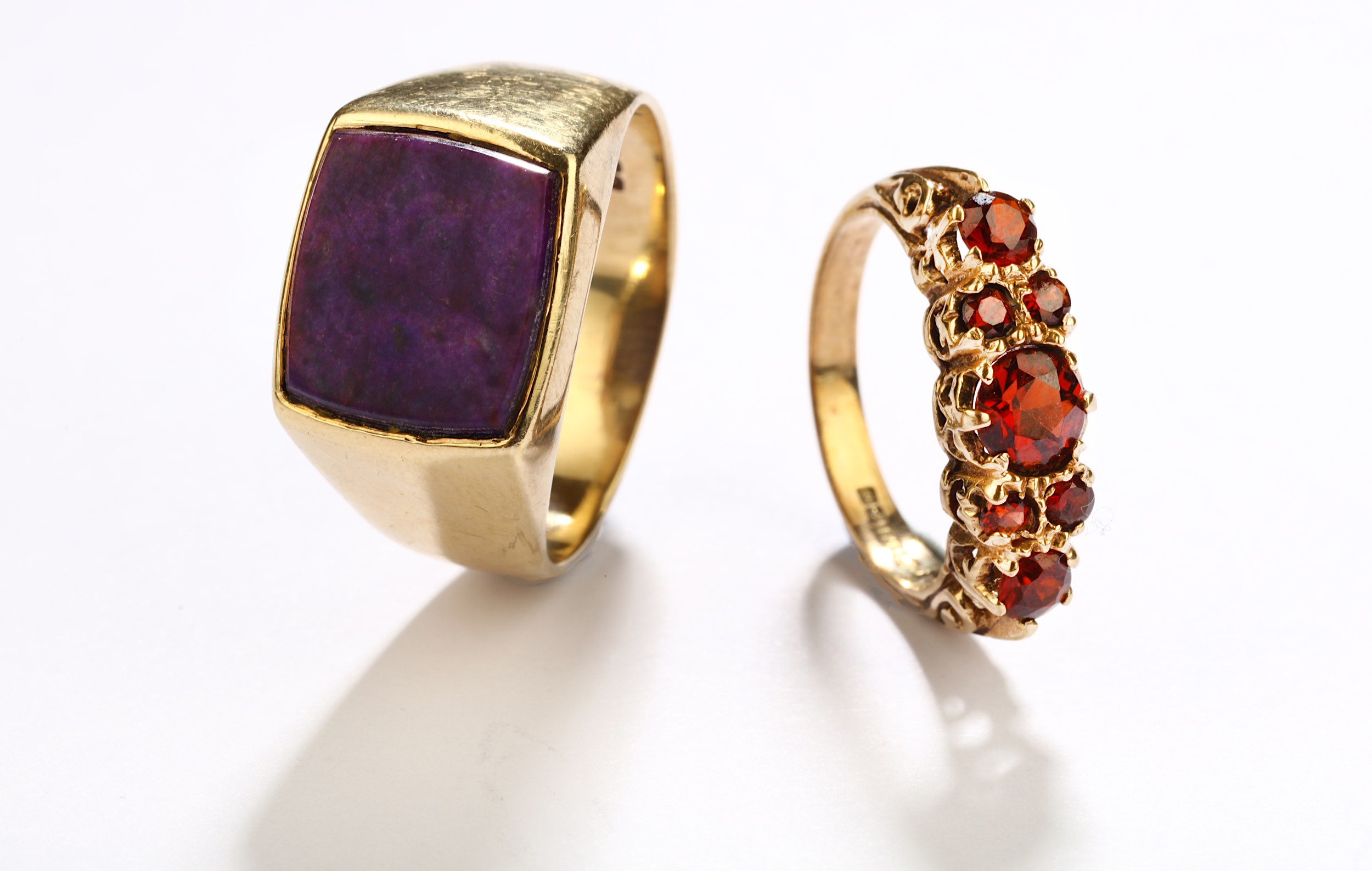 Two rings, 1st: A garnet seven-stone ring, 1978, the circular-cut garnets set in 9 carat gold, UK