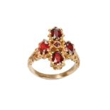 A garnet dress ring, set with oval-cut garnets in an elaborate gallery and shoulders, mounted in 9