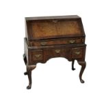 A small George I design walnut bureau, 18th Century and later, the banded fall enclosing a fitted