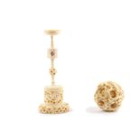 A Chinese carved ivory puzzle ball and stand, early 20th Century, the carved dragon encrusted