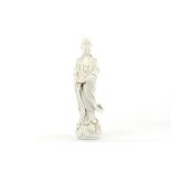 A Chinese Blanc de Chine Guanyin figure, 20th Century, modelled standing on a lotus and wave base,