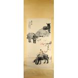 A collection of three Chinese ink paintings on paper, the hanging scroll depicting three oxen