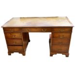 A good Edwardian mahogany cased pedestal desk, with an inset leather writing surface above three