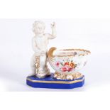An unusual figural porcelain inkstand, 19th century, probably French, the bisque figure of Cupid