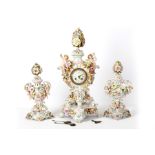 A Sitzendorf porcelain clock garniture, late 19th Century, the flower encrusted bodies on separate