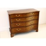 An English George III mahogany serpentine chest, circa 1800, fitted with four graduated long