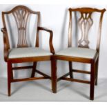 A set of seven mahogany dining chairs, including three carvers, with pierced backs on square legs (