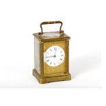 A fine French gilded brass carriage clock, late 19th Century, with bevelled glass panels to all four