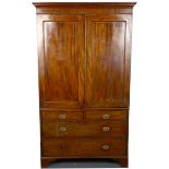 A mahogany linen press, early 19th Century, with twin panelled doors over drawers to the base, 195cm