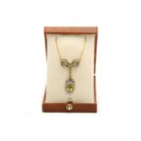 A peridot and diamond pendant necklace, of bow des