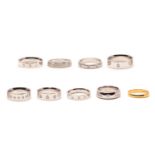 A collection of band rings, One 22 carat gold band ring, and eight 9 carat white gold rings accented