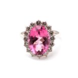 A pink tourmaline and diamond cluster ring, The oval-cut pink tourmaline in a brilliant-cut