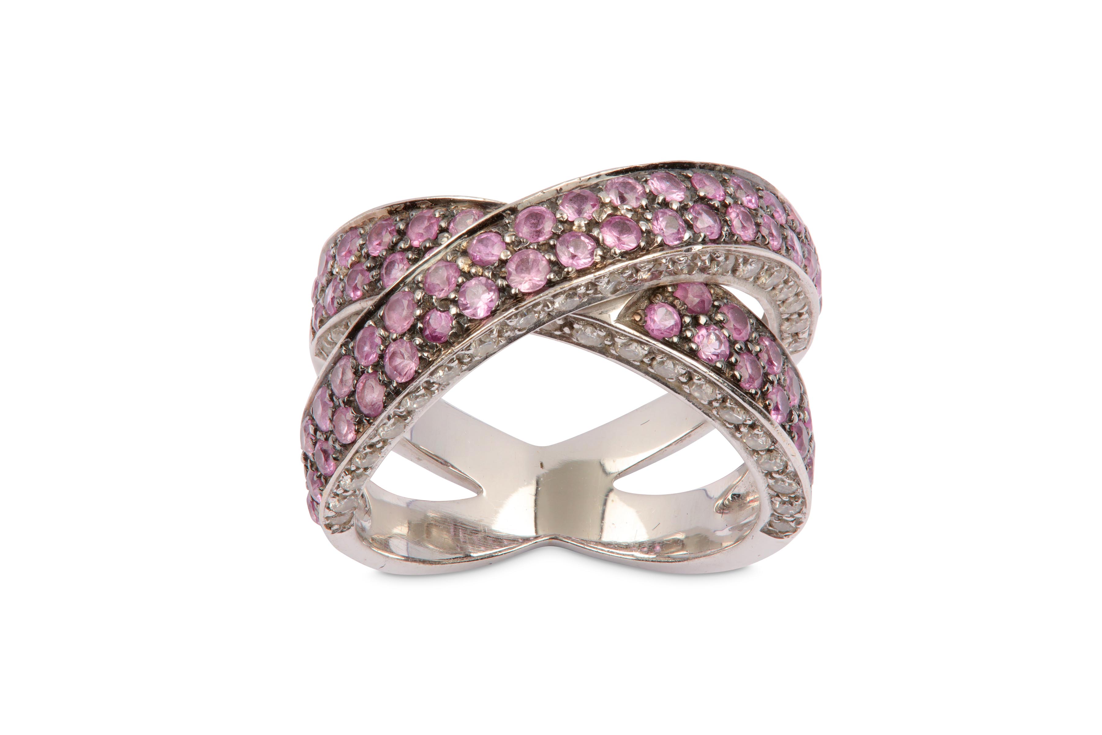 A pink sapphire and diamond crossover ring