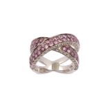 A pink sapphire and diamond crossover ring