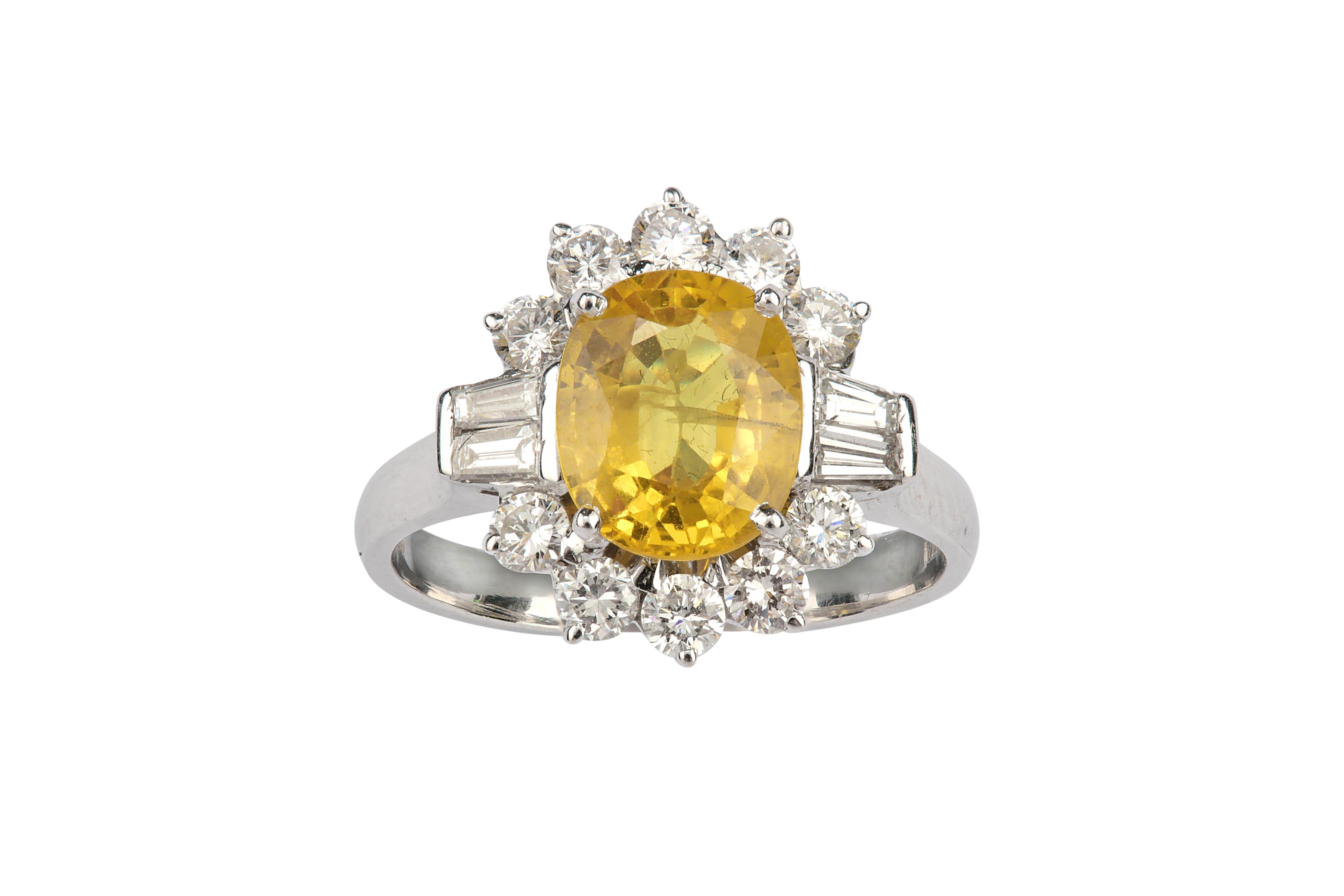 A yellow sapphire and diamond cluster ring