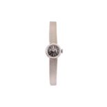 UNIVERSAL. AN 18K WHITE GOLD MANUAL WIND BRACELET WATCH.  Case reference: 76400.    Date: C.1960