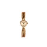 OMEGA. A LADIES 9K GOLD AND DIAMOND SET MANUAL WIND BRACELET WATCH.  Date: 1959. Serial number/