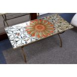 A 1960's design coffee table, the rectangular top set with a silvered floral paper top, on brass
