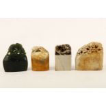A group of four carved Chinese soapstone seals, three carved with dragon(s) chasing flaming ball and