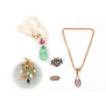 A group of jewellery, including an opal pendant necklace, a carved jade pendant mounted with a spray