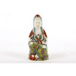 A Chinese enamelled model of Guanyin, Qing dynasty, the figure seated in brightly enamelled