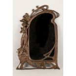 A Polish Art Nouveau cast metal dressing table mirror, early 20th Century, supported by a