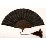 A carved tortoiseshell fan with silk box, 19th Century, pierced on top of each section decorated